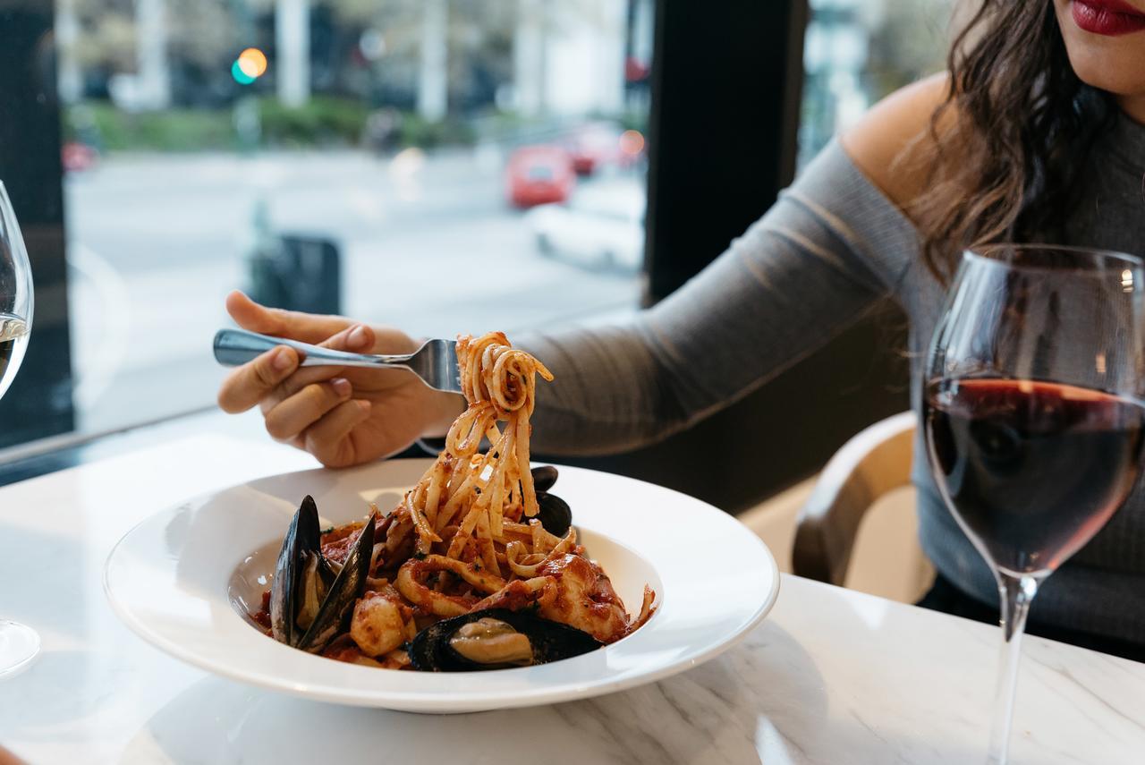 Art Series - The Chen Box Hill Exterior photo A woman eating a pasta dish